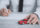 Person signing PCP claim form while holding toy car, showing how long does a PCP claim take.